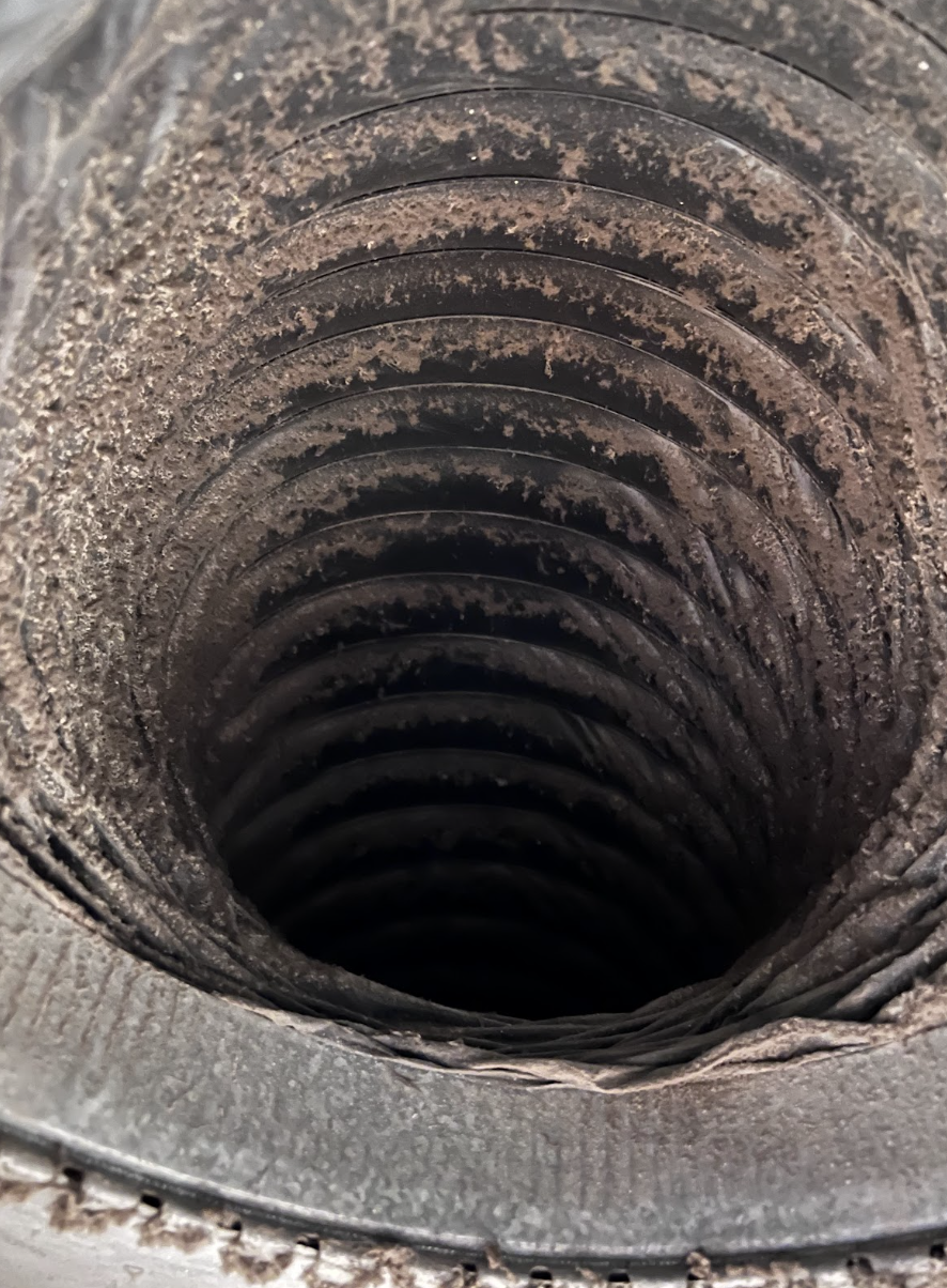 Air duct interior heavily coated with dust before cleaning