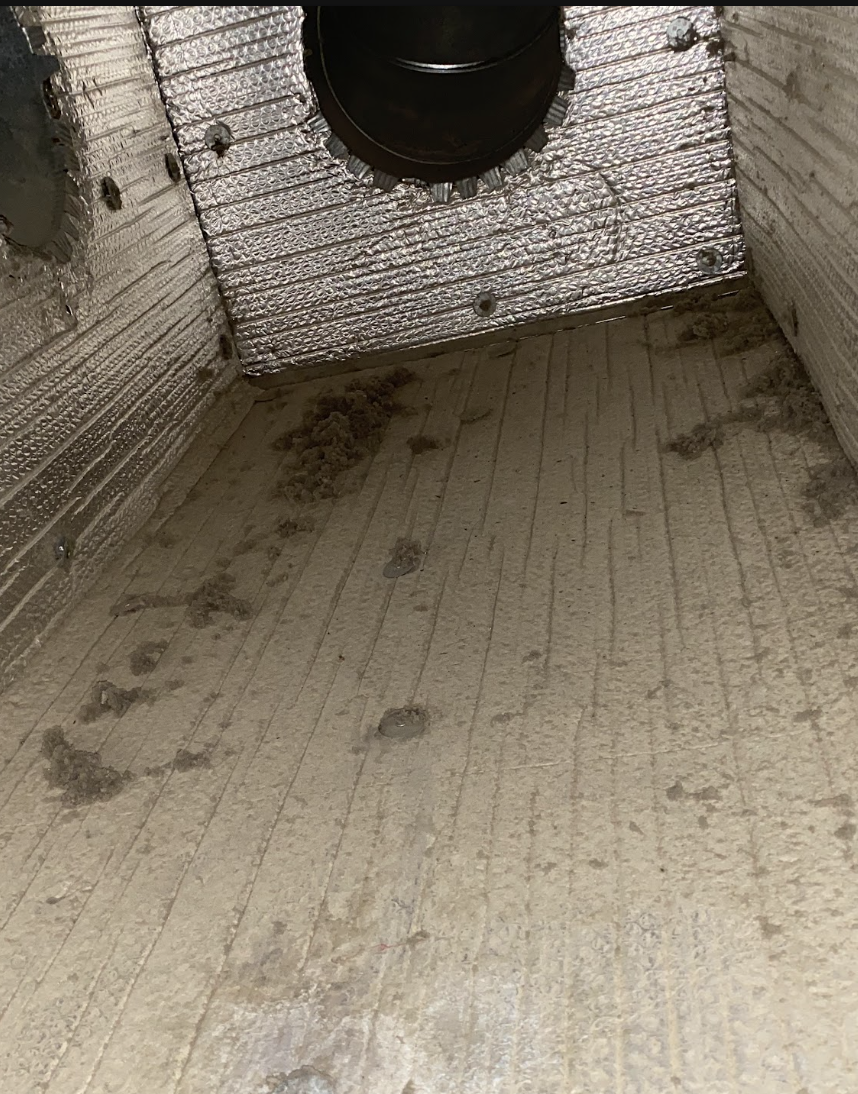 Dryer vent cavity filled with lint before cleaning